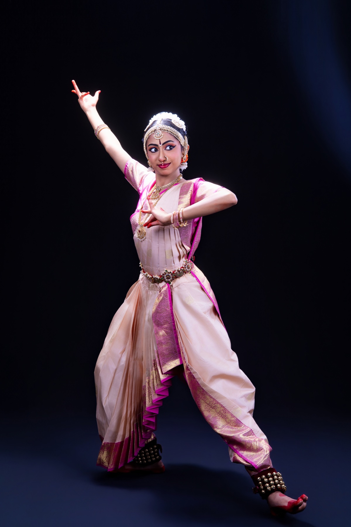Aadhya in a cream and pink Bharatanatyam costume
