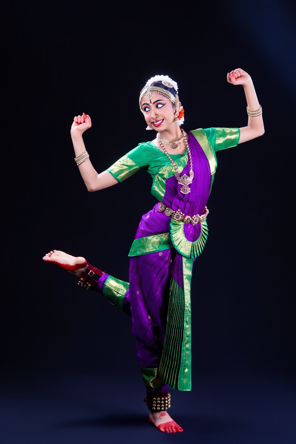 Aadhya dancing in a purple and green costume